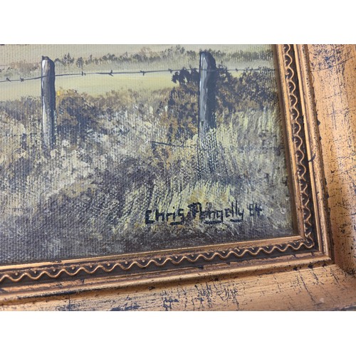 17 - Two oils on canvas of the same church in a landscape in Winter and Summer signed Chris Pengelly '84