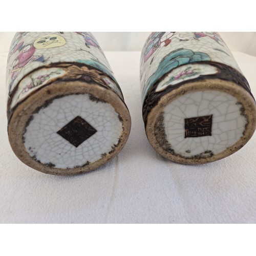 24 - Pair of enamelled oriental baluster vases depicting battle scenes (one damaged repaired)