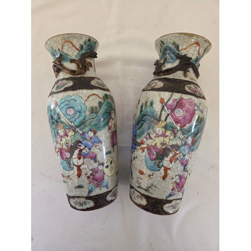 24 - Pair of enamelled oriental baluster vases depicting battle scenes (one damaged repaired)