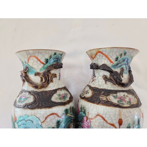 24 - Pair of enamelled oriental baluster vases depicting battle scenes (one damaged repaired)
