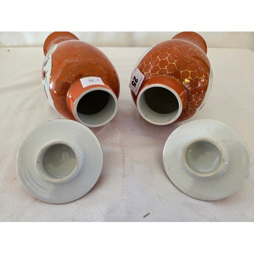 25 - Pair of Japanese covered baluster jars with panels of dragons and birds on an orange and gilt ground