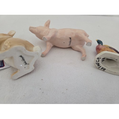 63 - Three Beswick gloss animal figurines, standing rabbit, white pig and cock pheasant