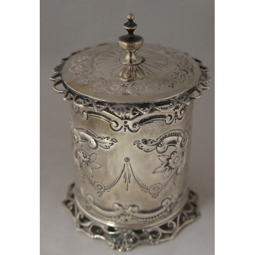 4 - A silver cylindrical container, London 1896, maker George Maudsley Jackson, with hinged lid and embo... 