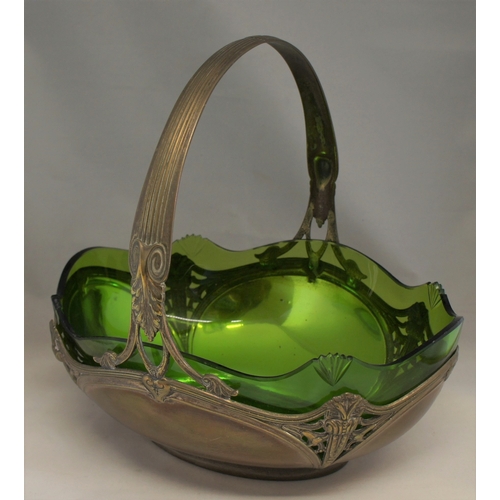 7 - An art nouveau pewter and glass fruit basket, early 20th century, with fixed reeded handle, the bask... 