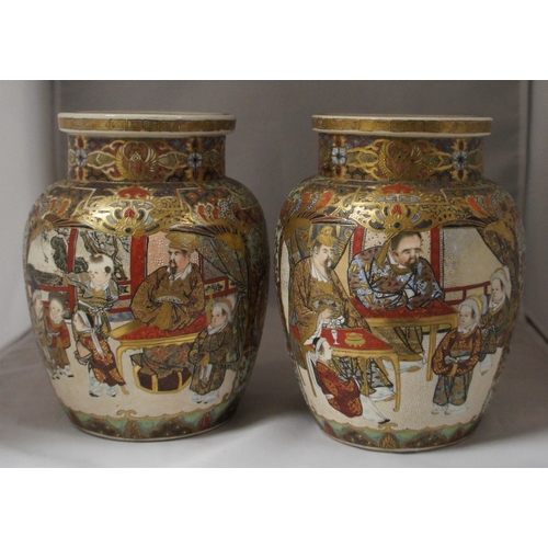 16 - A pair  of Satsuma vases, of squat baluster form with typical extensive decoration, 18 cm. high.