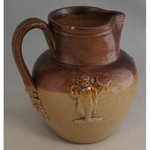 31 - A 19th century stoneware cream jug, with three applied musician figures and reeded handle with leaf ... 