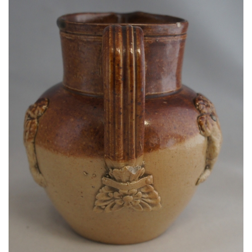 31 - A 19th century stoneware cream jug, with three applied musician figures and reeded handle with leaf ... 