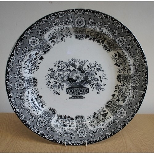 58 - A London Factory circular charger with printed black transfer, the fancy scroll and floral border en... 