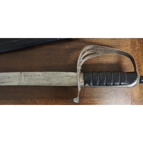 65 - A curved sword, with pierced steel hilt and leather grip, the scabbard leather cased, the steel blad... 