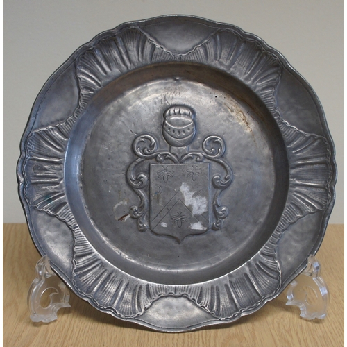 21 - Set of four pewter wall plaques, with animal and other armorial centres.