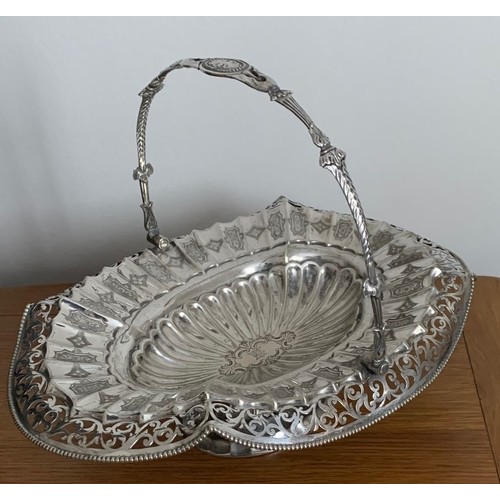 55 - Victorian silver plated basket, with swing handle and extensive pierced and engraved decoration.