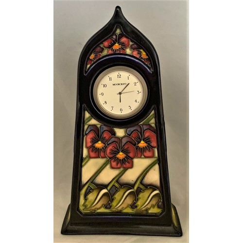 77 - Moorcroft pottery art nouveau style mantel clock, decorated in the Dames Pansy pattern, 23 cm high.