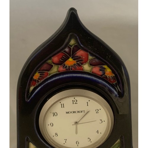 77 - Moorcroft pottery art nouveau style mantel clock, decorated in the Dames Pansy pattern, 23 cm high.