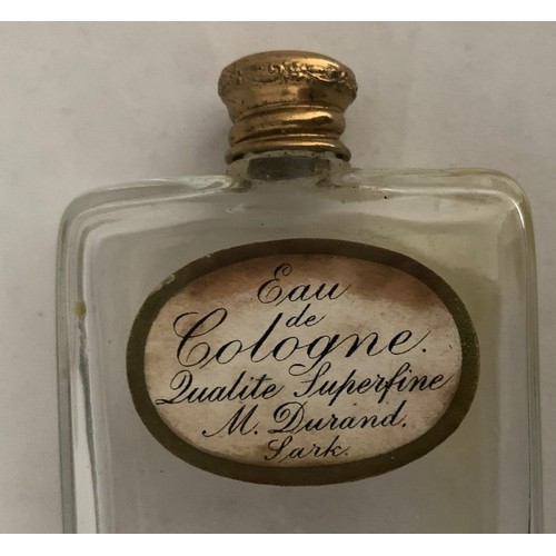 103 - Sark Eau de Cologne bottle, with gilt metal screw lid and paper label inscribed 'Eau de Cologne Qual... 