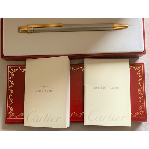 100 - A boxed and unused Cartier Stylo Must De Cartier ballpoint pen.