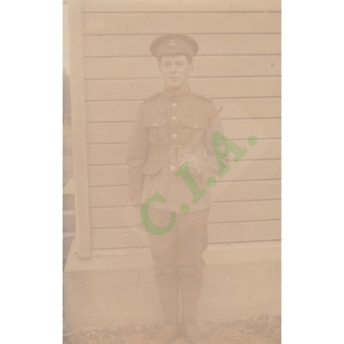 189 - Real photographic postcard, a soldier from the Royal Guernsey Light Infantry in uniform, holding a s... 