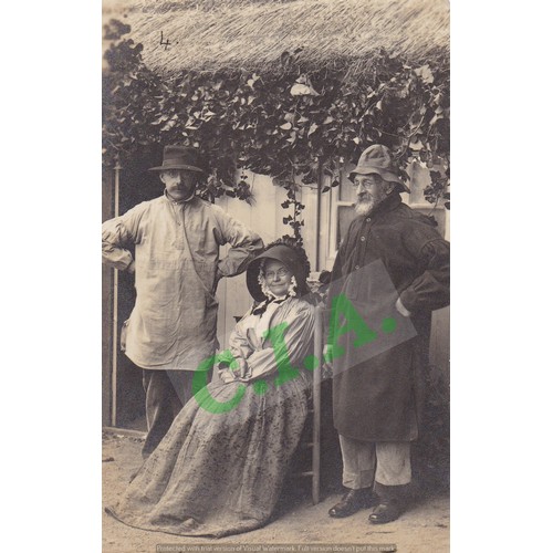 191 - Real photographic postcard, three people dressed in old Guernsey costumes outside a thatched cottage... 