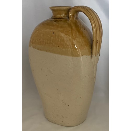 15 - Flat sided two tone glazed flagon with strap handle, 28 cm high.
