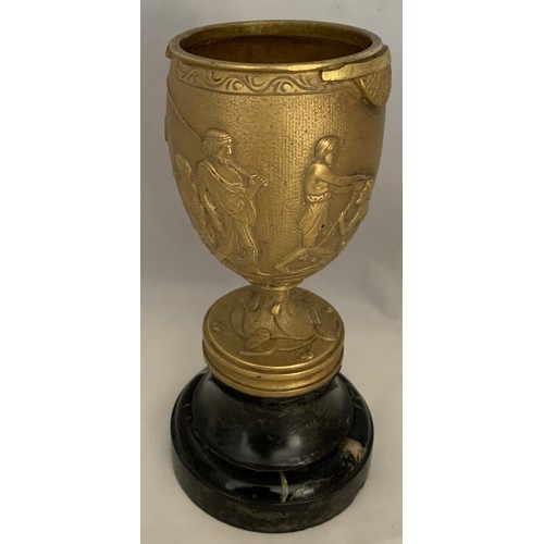 33 - A gilt brass Romanesque urn, 19th century, decorated with seven figures and a lion in high relief, s... 