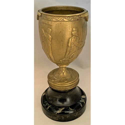 33 - A gilt brass Romanesque urn, 19th century, decorated with seven figures and a lion in high relief, s... 