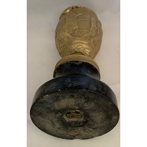 33 - A gilt brass Romanesque urn, 19th century, decorated with seven figures and a lion in high relief, s... 
