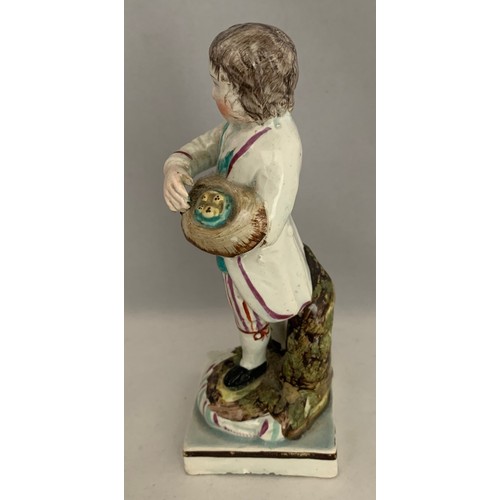 39 - Staffordshire pearlware figure circa 1840, with polychrome overglaze enamels, a boy carrying a bird'... 