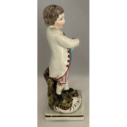 39 - Staffordshire pearlware figure circa 1840, with polychrome overglaze enamels, a boy carrying a bird'... 