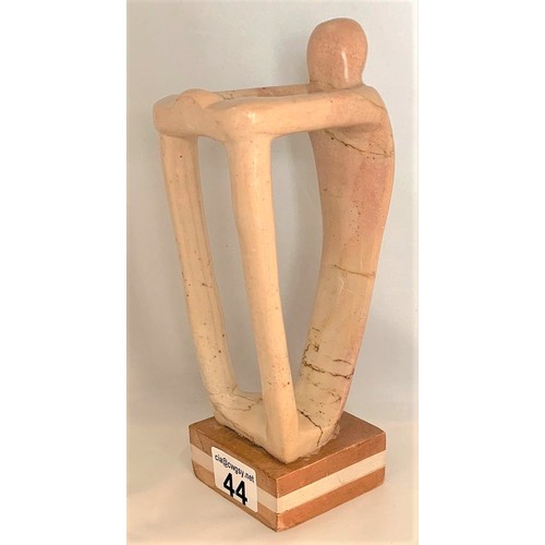 44 - A standing human-like figure, carved in alabaster, in the manner of Henry Spencer Moore, 24 cm high.