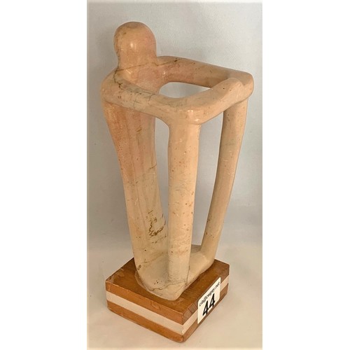 44 - A standing human-like figure, carved in alabaster, in the manner of Henry Spencer Moore, 24 cm high.