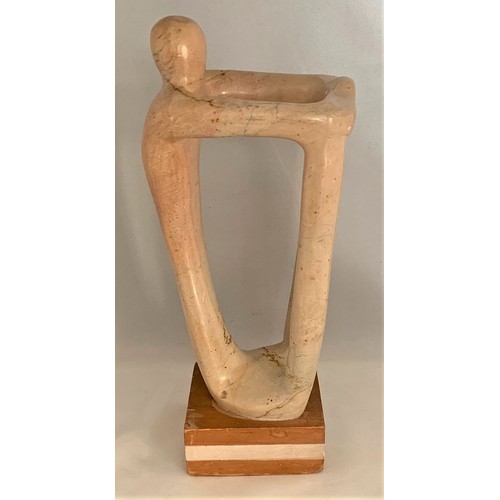 44 - A standing human-like figure, carved in alabaster, in the manner of Henry Spencer Moore, 24 cm high.