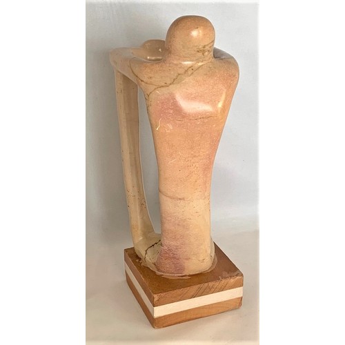 44 - A standing human-like figure, carved in alabaster, in the manner of Henry Spencer Moore, 24 cm high.
