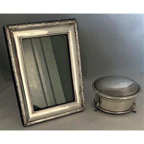 55 - A silver easel back photograph frame, together with a silver ring box with circular hinged lid, set ... 