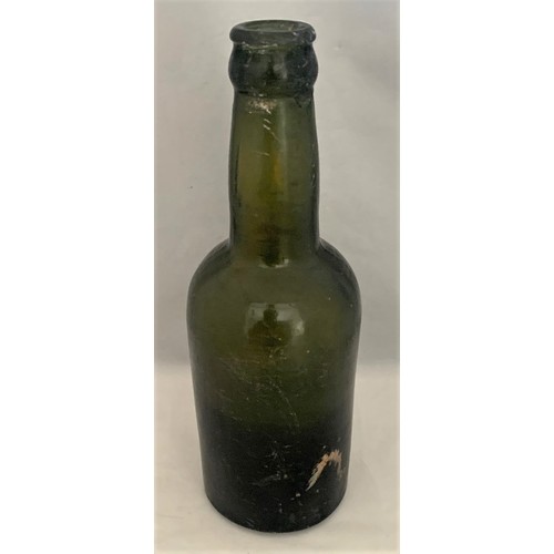 43 - Charles Kitts Guernsey, green glass beer bottle, 20 cm high.