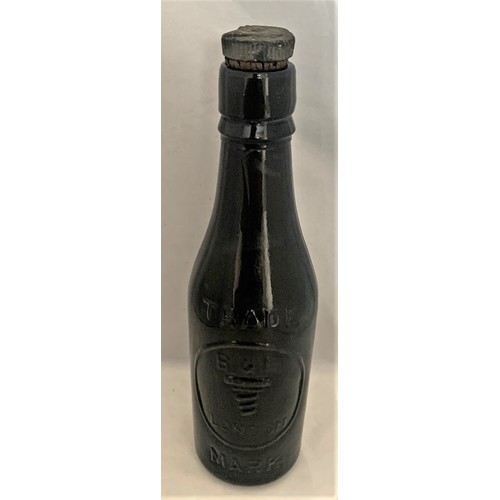 44 - R.H.Randall Guernsey, late 19th century black glass beer bottle with vulcanite screw cap, 23 cm high... 