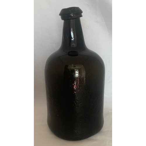 7 - English free blown black glass wine bottle c 1780, with deep kick to base, 26 cm. high.