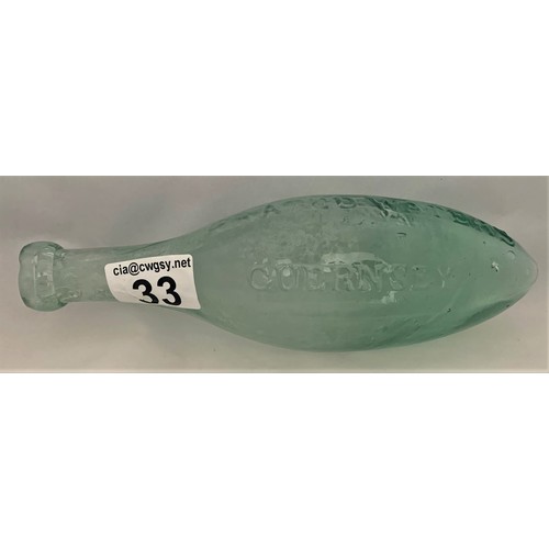 33 - A very rare clear glass Hamilton/Torpedo bottle, T.G. Reynolds Aerated Waters, Guernsey, 24 cm long.