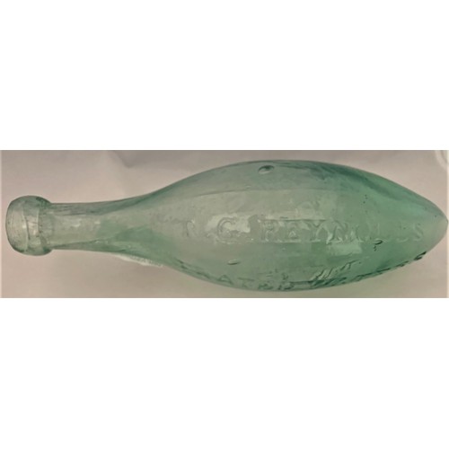 33 - A very rare clear glass Hamilton/Torpedo bottle, T.G. Reynolds Aerated Waters, Guernsey, 24 cm long.