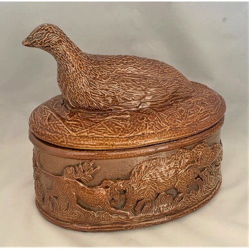 70 - English brown stoneware game pie dish, the lid decorated with a seated wildfowl, the base depicting ... 