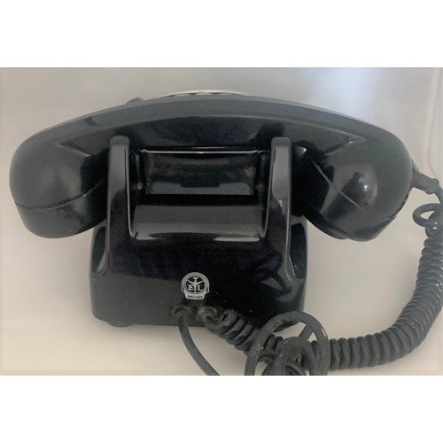 111 - A vintage black rotary dial telephone.