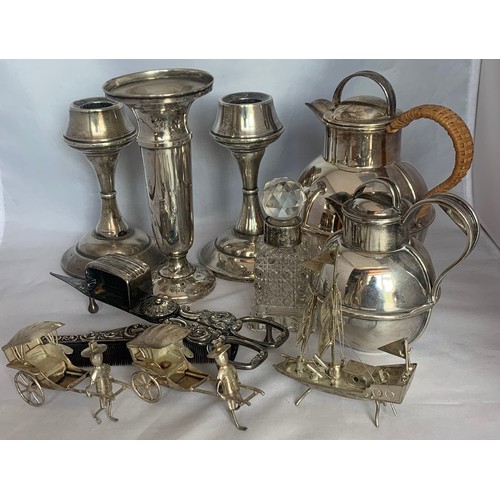 182 - Two EPNS Guernsey cans, white metal Oriental figures, three silver cased candlesticks etc. a/f.