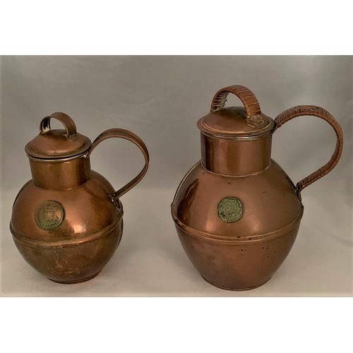 29 - Two copper Guernsey milk cans, by Martin's and G.A.Martin & Sons Ltd. Guernsey, one with wicker hand... 