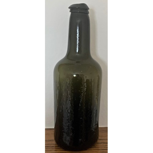 37 - Free blown green glass wine bottle, with applied lip and deep kick to base, 26 cm high.