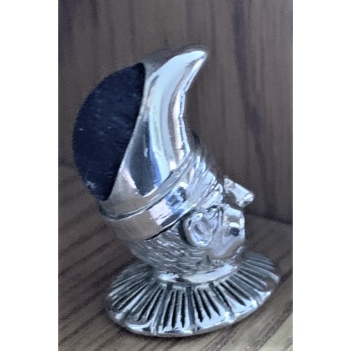 79 - A Sterling silver pin cushion in the form of a Court Jester, 10cm high.