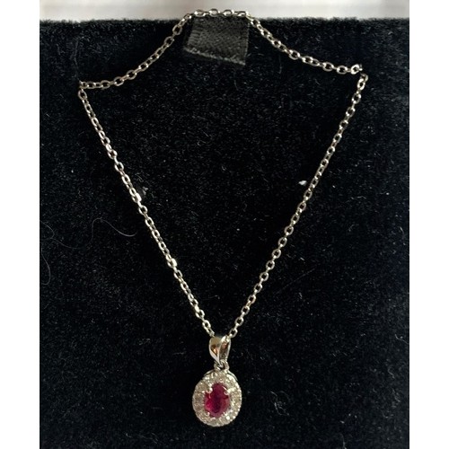 82 - An 18 carat white Gold, Ruby and Diamond pendant necklace, total 55 points.