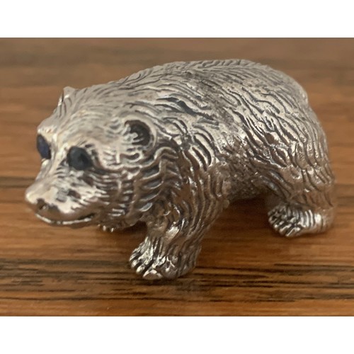 87 - A cast Sterling Silver grizzly bear cub figure with Emerald eyes, 3.5 cm wide.