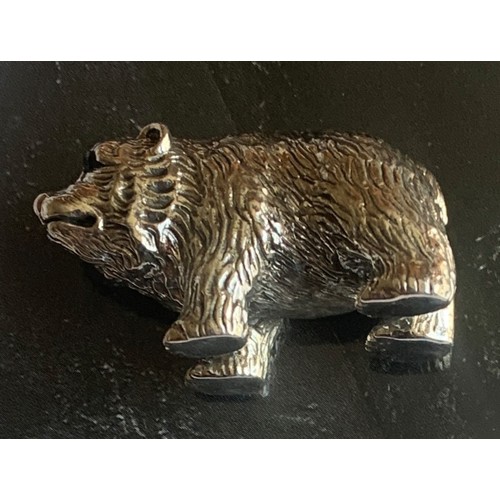 87 - A cast Sterling Silver grizzly bear cub figure with Emerald eyes, 3.5 cm wide.