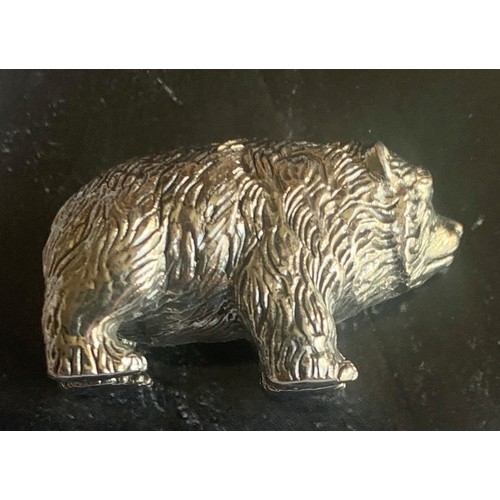 87 - A cast Sterling Silver grizzly bear cub figure with Emerald eyes, 3.5 cm wide.