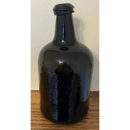 22 - English free blown black glass wine bottle c 1780, with deep kick to base, 26 cm. high.