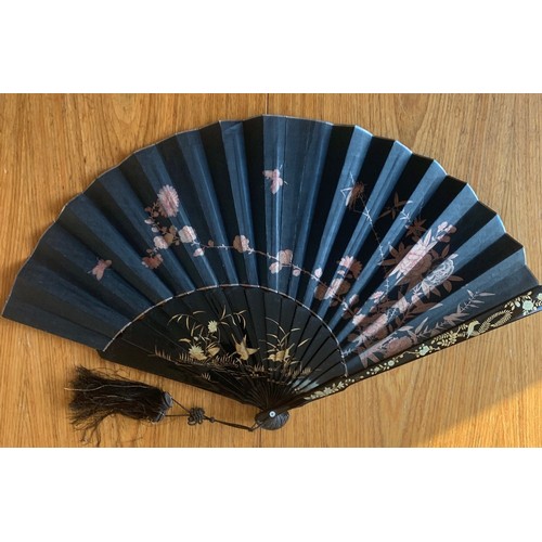 181 - A Chinese wooden fan, early 20th century, with black lacquered and gilt painted decoration depicting... 