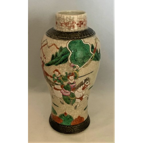 66 - A Chinese crackle glaze vase, of baluster form depicting fighting warriors. 23 cm high.